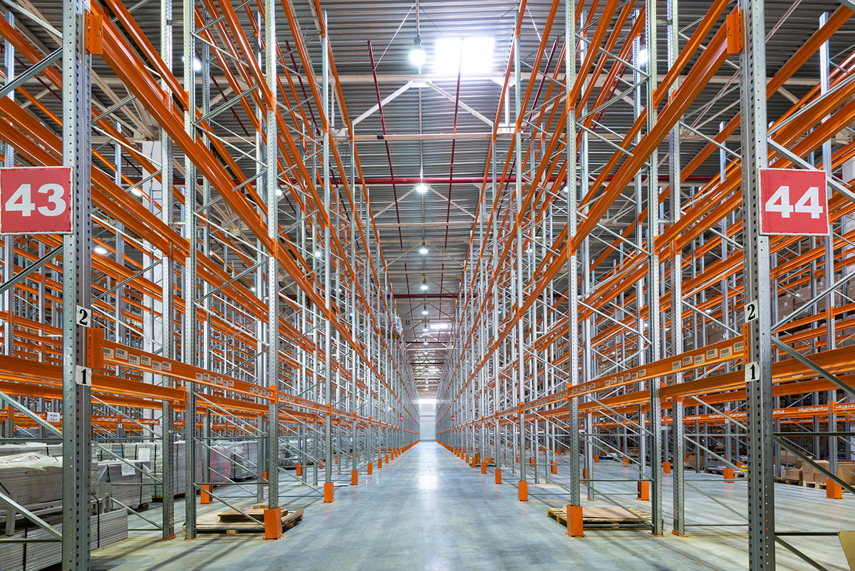 A large empty warehouse with orange framework